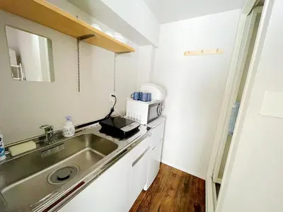 a small kitchen with a sink and a microwave at Hotel Tiffany in Tokyo