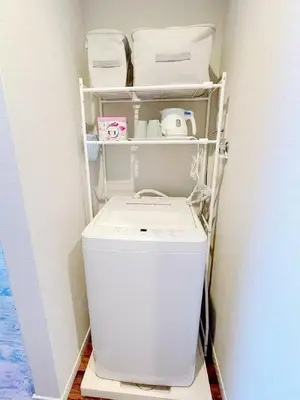 a washer and dryer in a corner of a room at Hotel Tiffany in Tokyo