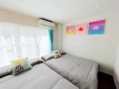 a bedroom with two beds in front of a window at Hotel Tiffany in Tokyo