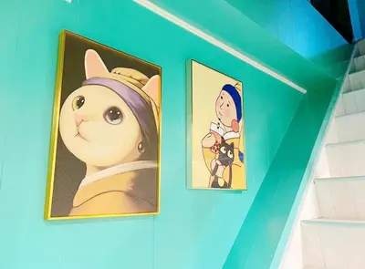 two paintings of a cat on a blue wall at Hotel Tiffany in Tokyo