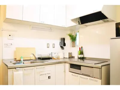 a kitchen with white cabinets and a sink and a counter at OHANA TOKYO HOUSE - Vacation STAY 71468v in Tokyo