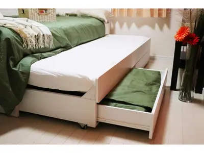 a white bed with a pull out drawer next to it at OHANA TOKYO HOUSE - Vacation STAY 73215v in Tokyo