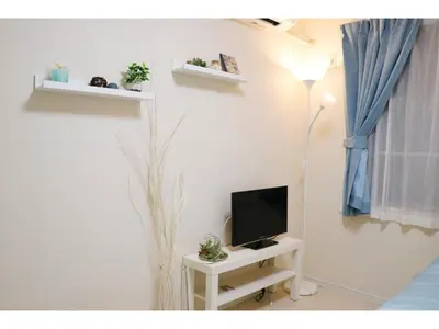 a living room with a tv and a table with a lamp at OHANA TOKYO HOUSE - Vacation STAY 73223v in Tokyo