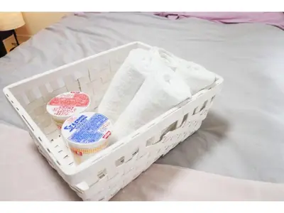 a basket sitting on a bed with some food at OHANA TOKYO HOUSE - Vacation STAY 73216v in Tokyo