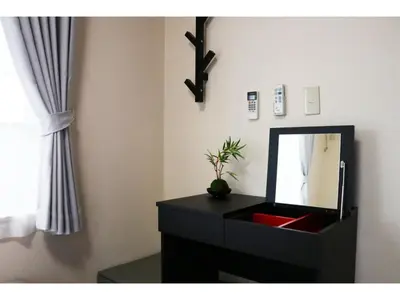 a bathroom with a black dresser with a mirror at OHANA TOKYO HOUSE - Vacation STAY 73216v in Tokyo