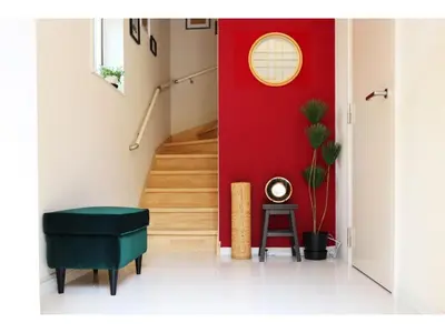a hallway with a red wall and a stairway at OHANA TOKYO HOUSE - Vacation STAY 73208v in Tokyo