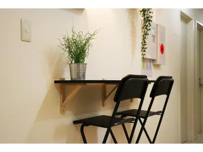a table with two chairs and a potted plant on it at OHANA TOKYO HOUSE - Vacation STAY 73208v in Tokyo