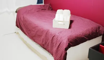 a bed with two rolls of toilet paper on it at OHANA TOKYO HOUSE - Vacation STAY 73208v in Tokyo