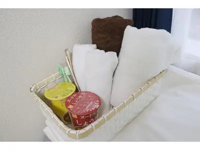 a basket filled with towels and toothbrushes at OHANA TOKYO HOUSE - Vacation STAY 73654v in Tokyo