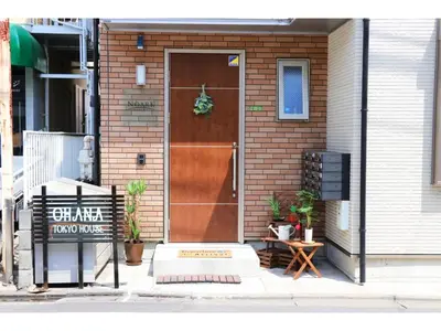 a house with a brown door with a wreath on it at OHANA TOKYO HOUSE - Vacation STAY 71661v in Tokyo