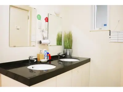 a bathroom with two sinks and a mirror at OHANA TOKYO HOUSE - Vacation STAY 71660v in Tokyo