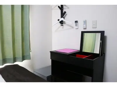 a bedroom with a dresser with a mirror on it at OHANA TOKYO HOUSE - Vacation STAY 71660v in Tokyo