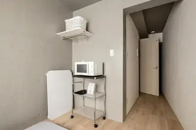 a kitchen with a refrigerator and a microwave at Marvelous Ryogoku - Vacation STAY 73442v in Tokyo