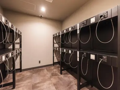 a room with several racks of tennis rackets at Sotetsu Fresa Inn Daimon in Tokyo
