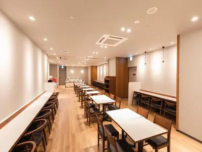 a row of tables and chairs in a restaurant at Sotetsu Fresa Inn Daimon in Tokyo