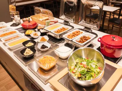 a buffet with many different types of food on a counter at Sotetsu Fresa Inn Daimon in Tokyo