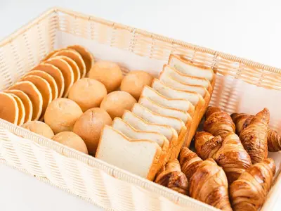 a basket filled with different types of bread and pastries at Sotetsu Fresa Inn Daimon in Tokyo