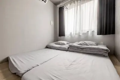 two beds in a white room with a window at Marvelous Ryogoku - Vacation STAY 74211v in Tokyo