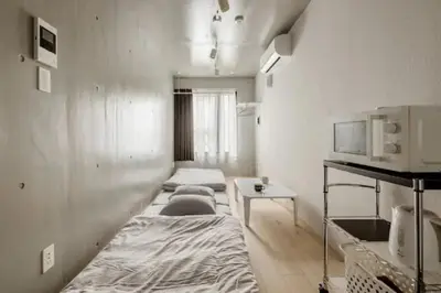 a room with two beds and a table in it at Marvelous Ryogoku - Vacation STAY 74212v in Tokyo