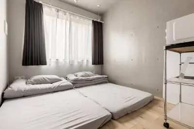 a bedroom with two beds and a window at Marvelous Ryogoku - Vacation STAY 74214v in Tokyo