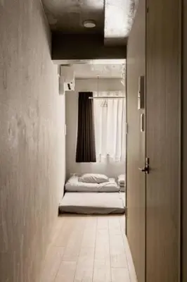 a hallway with two beds in a room with a door at Marvelous Ryogoku - Vacation STAY 74214v in Tokyo