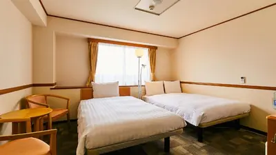 a hotel room with two beds and a window at Toyoko Inn Tokyo Tozai-sen Nishi-kasai in Tokyo