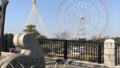 a large ferris wheel in a park with a bench at Toyoko Inn Tokyo Tozai-sen Nishi-kasai in Tokyo