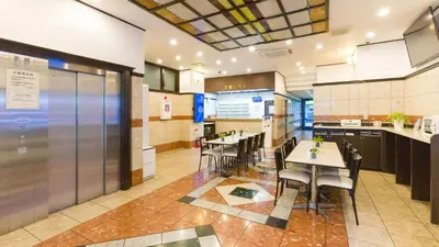 a restaurant with tables and chairs in a room at Toyoko Inn Tokyo Kamata Higashi-guchi in Tokyo