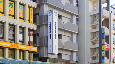 a building with a sign on the side of it at Toyoko Inn Tokyo Kamata Higashi-guchi in Tokyo