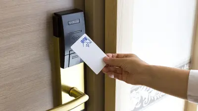 a person unlocking a door with a piece of paper at Toyoko Inn Tokyo Shinagawa-eki Takanawa-guchi in Tokyo