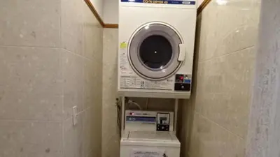 a washing machine and a washer in a bathroom at Toyoko Inn Tokyo Shinagawa-eki Takanawa-guchi in Tokyo