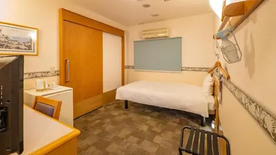 a small room with a bed and a window at Toyoko Inn Tokyo Asakusa Kuramae No 1 in Tokyo
