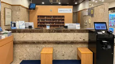 a library with a counter with a laptop on it at Toyoko Inn Tokyo Asakusa Kuramae No 1 in Tokyo
