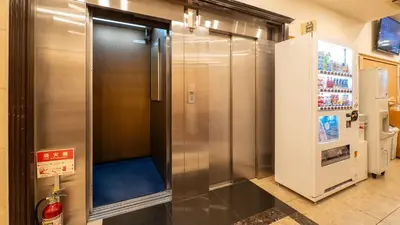 a large metal elevator in a room with a refrigerator at Toyoko Inn Tokyo Asakusa Kuramae No 1 in Tokyo