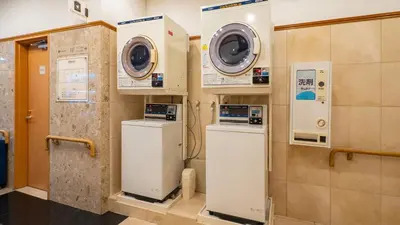 a laundry room with two washes and two machines at Toyoko Inn Tokyo Asakusa Kuramae No 1 in Tokyo
