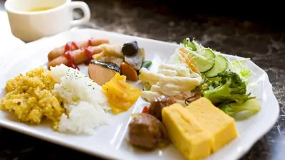 a plate of food with rice and vegetables and a cup of coffee at Toyoko Inn Tokyo Asakusa Kuramae No 1 in Tokyo