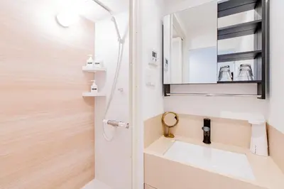 a bathroom with a sink and a mirror at STone Hotel in Tokyo