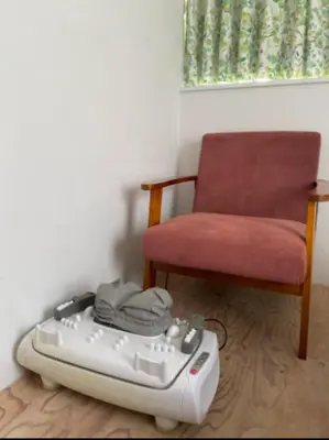 a suitcase sitting on the floor next to a chair at &y Kitasenju in Tokyo