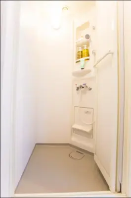 a white bathroom with a toilet and a sink at &y Kitasenju in Tokyo