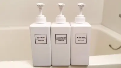 three white bottles sitting on top of a bath tub at Goodsite In Oshiage in Tokyo