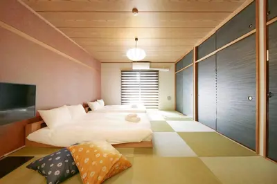 a bedroom with a large bed and a flat screen tv at Goodsite In Oshiage in Tokyo