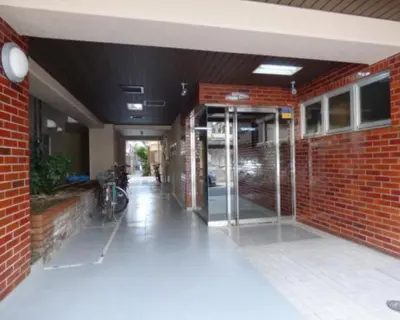 an entrance to a brick building with an open door at Great location Only 1 minute to St G-18 Ginza Line in Tokyo