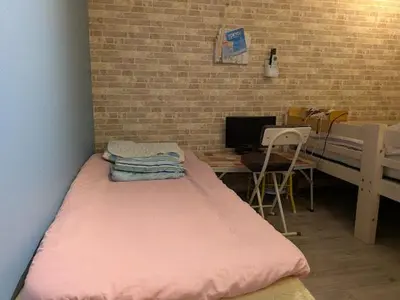 a room with a large pink bed and a desk at Great location Only 1 minute to St G-18 Ginza Line in Tokyo