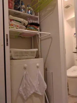 a bathroom with a closet with a washing machine at Great location Only 1 minute to St G-18 Ginza Line in Tokyo