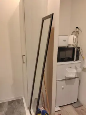 a mirror in the corner of a kitchen with a microwave at Great location Only 1 minute to St G-18 Ginza Line in Tokyo