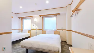 a room with two beds and two windows at Toyoko Inn Tokyo Nihombashi Ningyocho in Tokyo