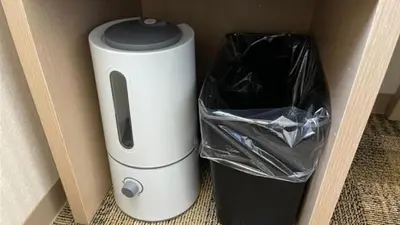 a white and black appliance sitting next to a trash can at Toyoko Inn Tokyo Akabane-eki Higashi-guchi Ichiban-gai in Tokyo