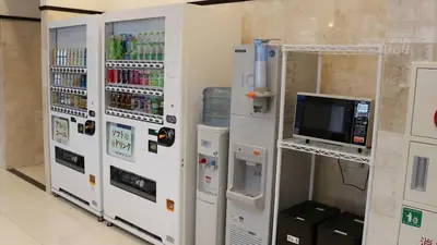 a row of white vending machines in a room at Toyoko Inn Tokyo Akabane-eki Higashi-guchi Ichiban-gai in Tokyo