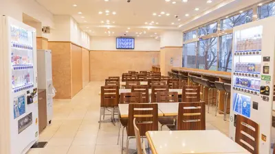 an empty classroom with tables and chairs in a cafeteria at Toyoko Inn Tokyo Monzen-nakacho Eitaibashi in Tokyo