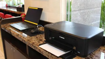 a black printer sitting on a counter with a laptop at Toyoko Inn Tokyo Uguisudani Ekimae in Tokyo